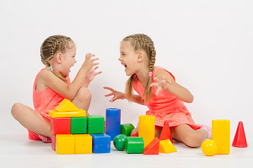 Image showing Two girls frighten each other by playing with blocks