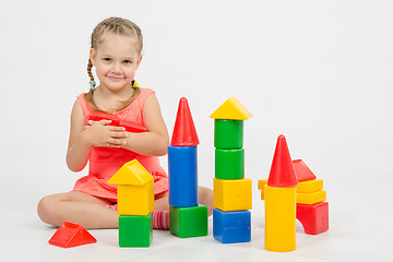 Image showing Girl holding two dice and smiles