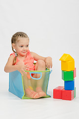 Image showing The girl got into box from under blocks