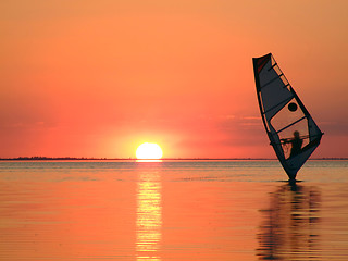 Image showing Silhouette of a windsurfer on waves of a gulf on a sunset 3