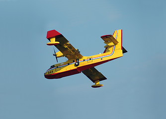 Image showing Firefighting airplane descending for water