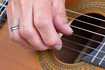 Image showing Old woman\'s hand playing guitar