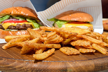 Image showing fresh burgers and fries on tray