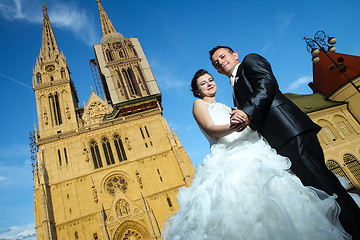 Image showing Newlyweds posing in front of Cathedral