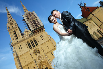 Image showing Bride and groom posing in front of Cathedral