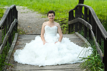 Image showing Bride on wooden bridge