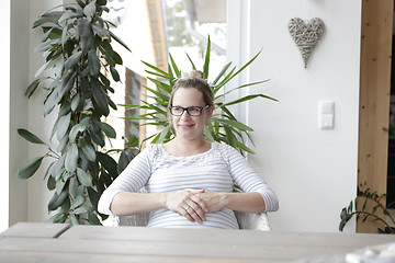 Image showing pregnant woman sitting at the table