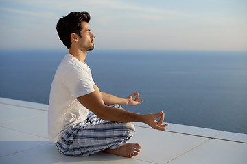 Image showing young man practicing yoga