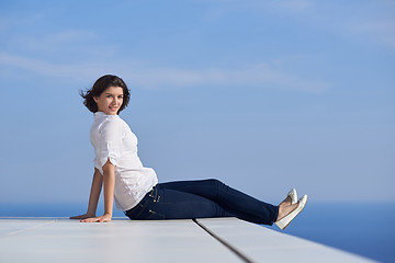 Image showing relaxed woman in front of luxury modern home