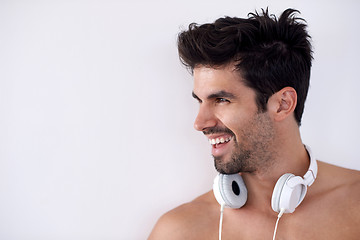 Image showing handsome young man listening music on headphones