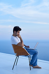 Image showing relaxed young man at home on balcony