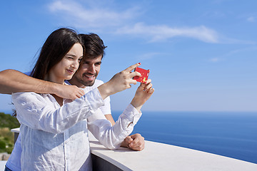 Image showing young couple taking selfie with phone