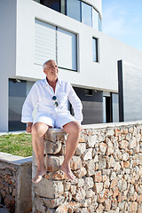 Image showing senior man in front of modern home