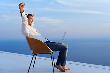 Image showing relaxed young man at home on balcony