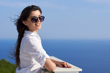 Image showing relaxed woman in front of luxury modern home