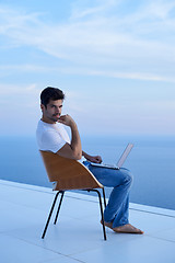 Image showing relaxed young man at home on balcony