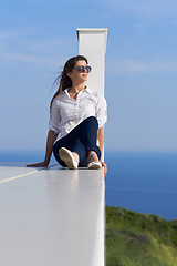 Image showing relaxed woman in front of luxury modern home