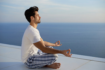 Image showing young man practicing yoga