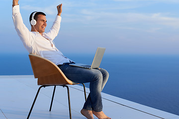 Image showing relaxed young man at home on balcony