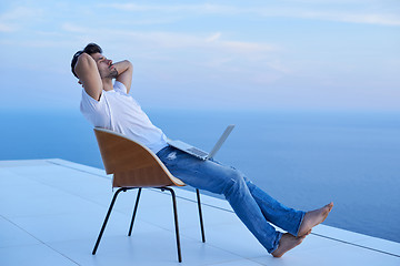 Image showing relaxed young man at home on balcony