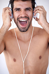 Image showing handsome young man listening music on headphones