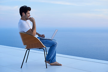 Image showing relaxed young man at home on balcony