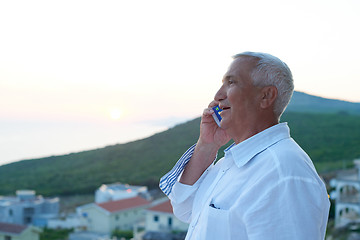 Image showing senior man using smart phone