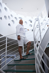 Image showing senior man in front of modern home