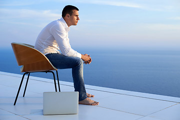 Image showing relaxed young man at home on balcony