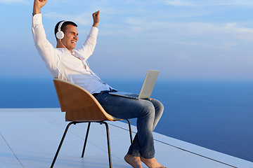 Image showing relaxed young man at home on balcony