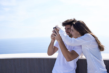 Image showing young couple taking selfie with phone