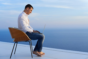 Image showing relaxed young man at home on balcony