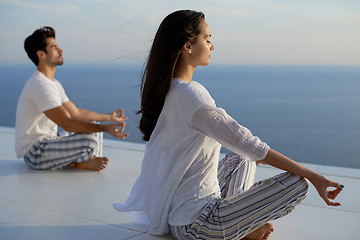 Image showing young couple practicing yoga