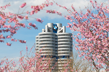 Image showing Tower building BMW head office framed pink spring flowering bran