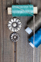 Image showing vintage buttons flowers and spools with threads