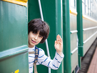 Image showing boy waves his hand from railcar