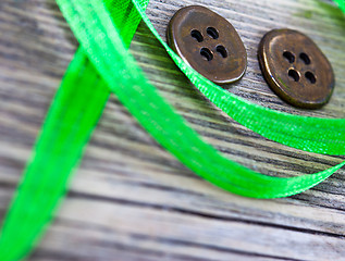 Image showing still life with old green tape and two vintage buttons