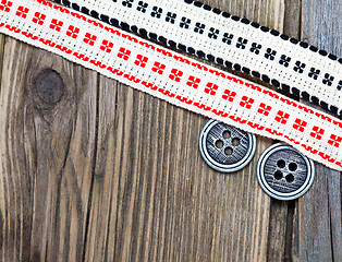 Image showing two vintage ribbons with embroidered ornaments and old buttons