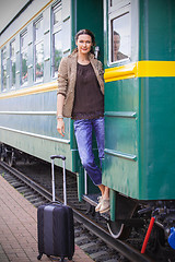 Image showing beautiful adult woman on the steps of the passenger car