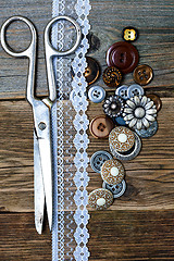 Image showing aged buttons, lace and a tailor scissors