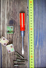 Image showing Vintage screwdriver, screws, angles and measuring tape