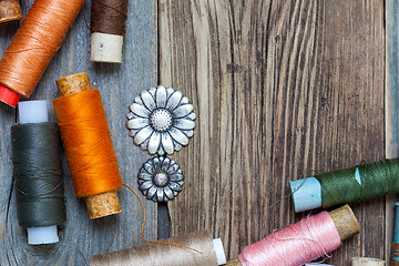 Image showing vintage buttons and old reels of varicolored thread