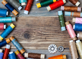 Image showing vintage reels of varicolored thread and old flower buttons