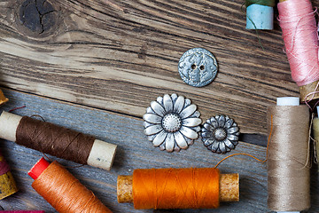 Image showing vintage reels of varicolored thread and old buttons