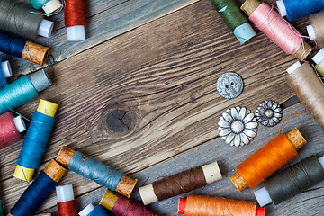 Image showing old reels of varicolored thread and vintage buttons