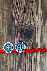 Image showing old red tape and two vintage classic buttons