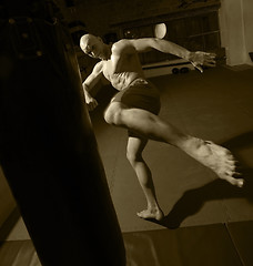 Image showing Kick boxer trains on punching bag