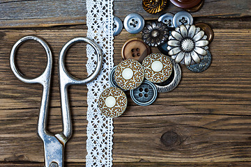 Image showing several vintage buttons, lace, and a dressmaker scissors