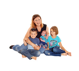 Image showing Mother with her three kids sitting on floor.