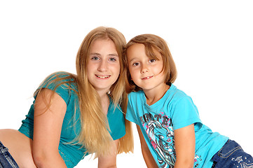 Image showing Two little sisters lying on the floor.